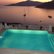 villa pool overlooking sea at sunset