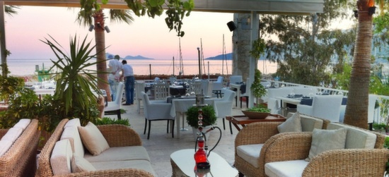 Rooftop restaurant setting with set tables at sunset